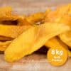 Pile of bright orange dried mango slices on a wooden surface with an orange 8 kg Bulk Product label in the corner