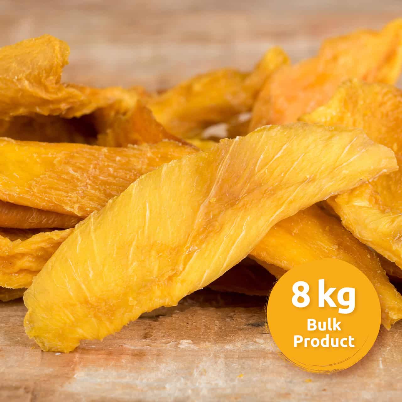 Pile of bright orange dried mango slices on a wooden surface with an orange 8 kg Bulk Product label in the corner